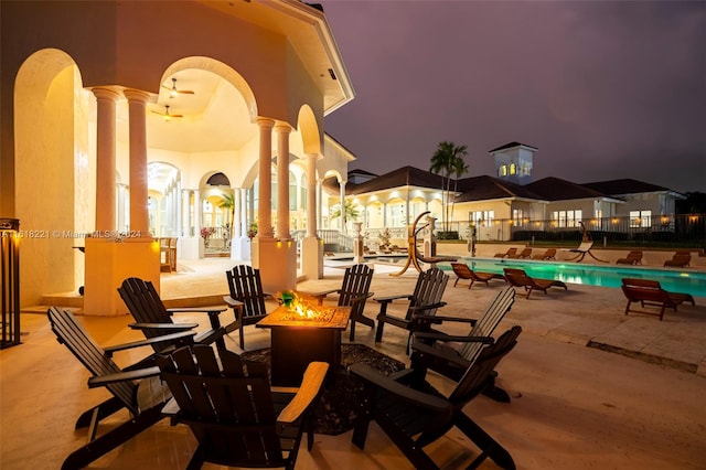 view of patio featuring a community pool and a fire pit