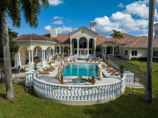 view of pool with a patio and a lawn