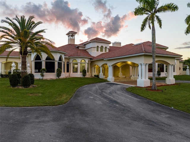 mediterranean / spanish-style home featuring a lawn