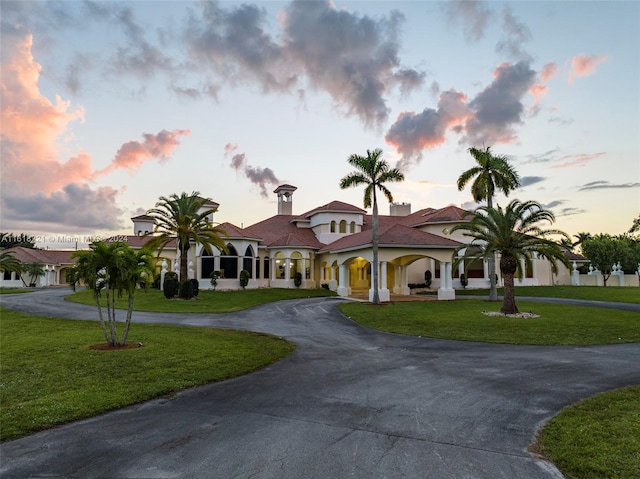 mediterranean / spanish-style house with a yard