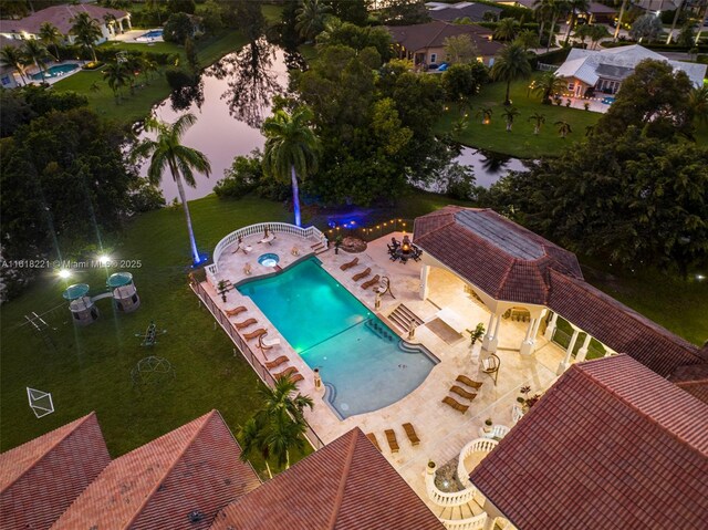 view of swimming pool with a patio and a lawn