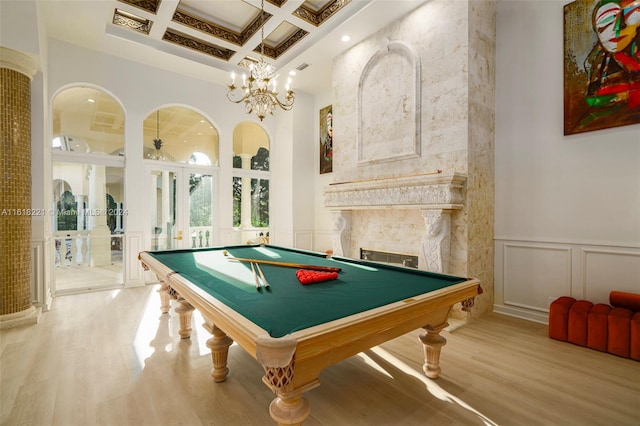 recreation room featuring a premium fireplace, beamed ceiling, light hardwood / wood-style flooring, pool table, and coffered ceiling