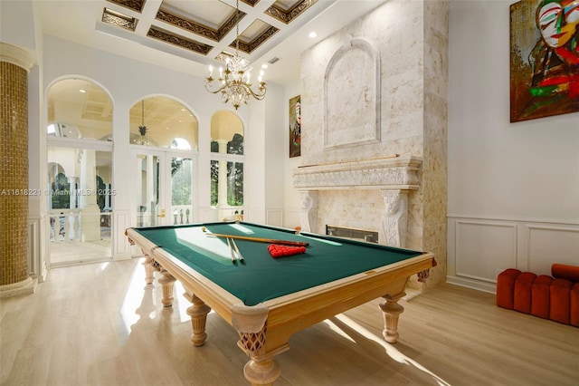 game room featuring french doors, coffered ceiling, wood-type flooring, beamed ceiling, and a high ceiling