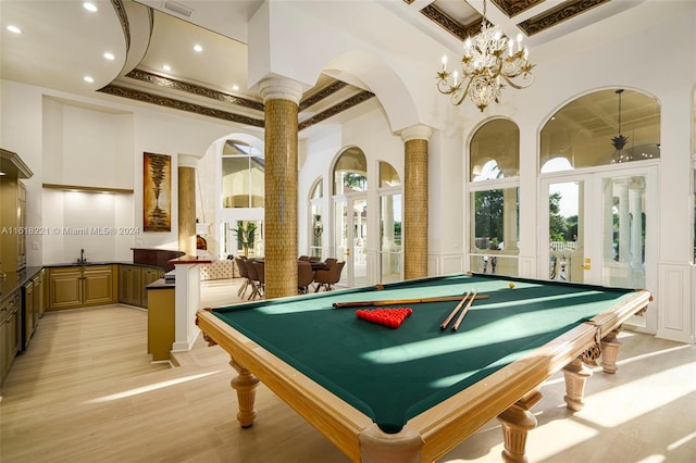 recreation room with a notable chandelier, billiards, coffered ceiling, french doors, and ornate columns