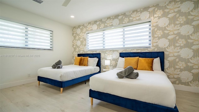 bedroom with ceiling fan and light hardwood / wood-style floors