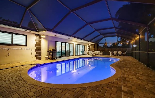 view of pool featuring a lanai and a patio