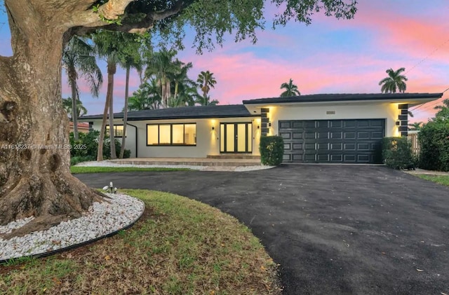 ranch-style home featuring a garage