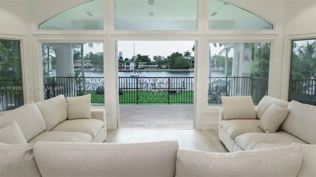 sunroom with a water view and plenty of natural light