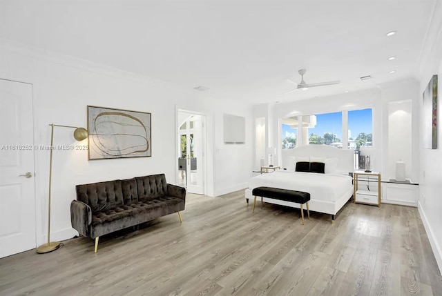 bedroom with crown molding, ceiling fan, and light wood-type flooring