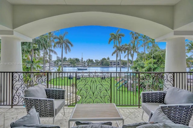 balcony featuring a water view and an outdoor hangout area