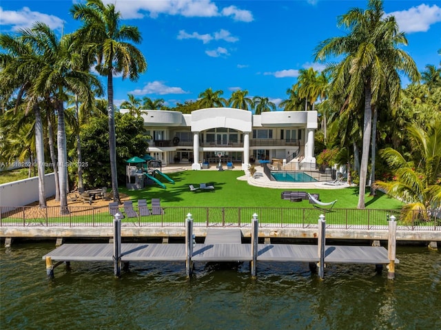 view of dock with a water view, a yard, and a playground