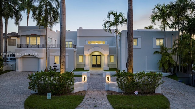 view of front of home featuring a garage and a balcony