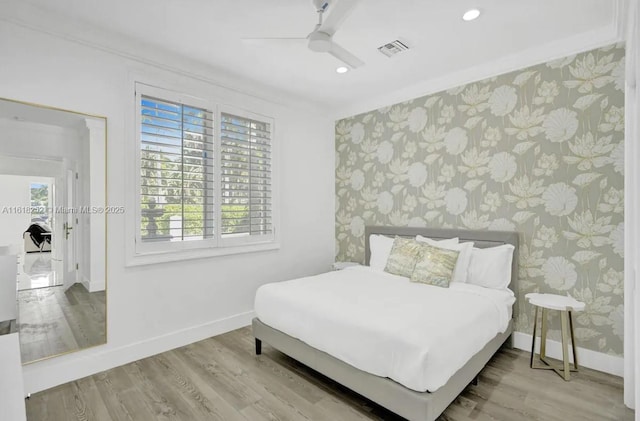 bedroom with ceiling fan and light wood-type flooring