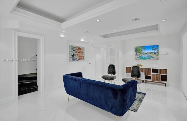 living room featuring a raised ceiling