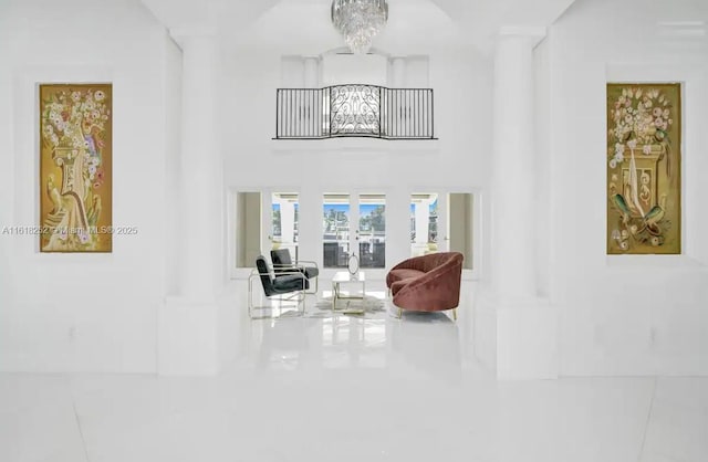 interior space featuring a chandelier and a high ceiling