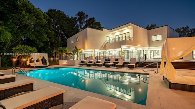 pool at twilight with a patio