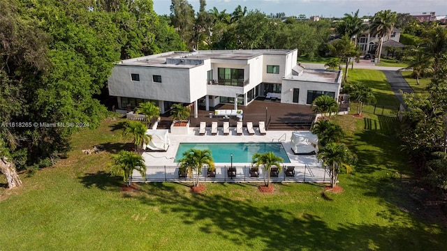 back of property featuring a fenced in pool, a patio area, and a balcony