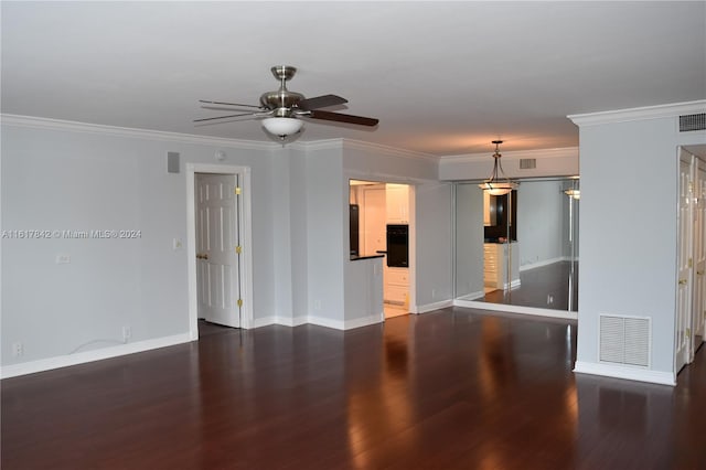 spare room with ceiling fan, dark hardwood / wood-style flooring, and ornamental molding