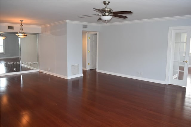 spare room featuring dark hardwood / wood-style floors, ceiling fan, and crown molding