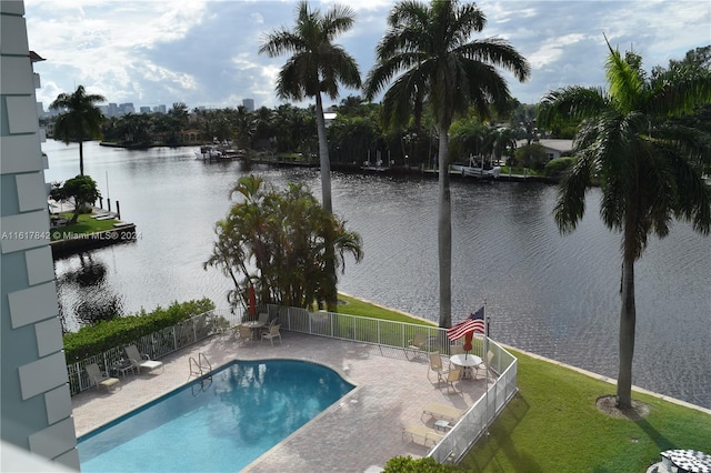 view of pool featuring a patio and a water view