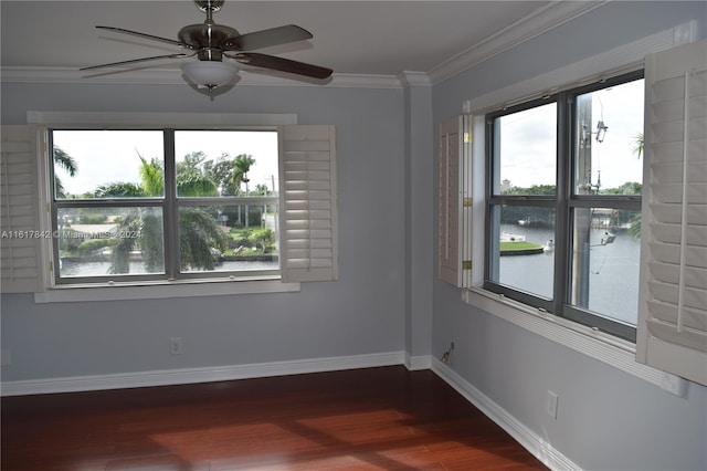 spare room featuring ceiling fan, crown molding, a water view, and dark wood-type flooring