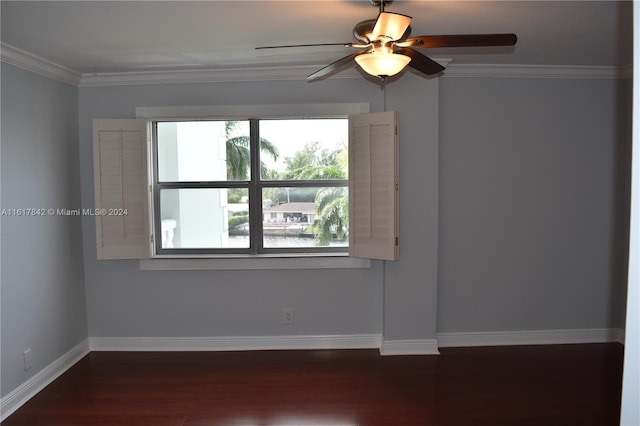 spare room featuring ornamental molding, ceiling fan, and dark wood-type flooring