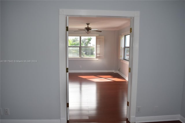 empty room with wood-type flooring, ceiling fan, and crown molding