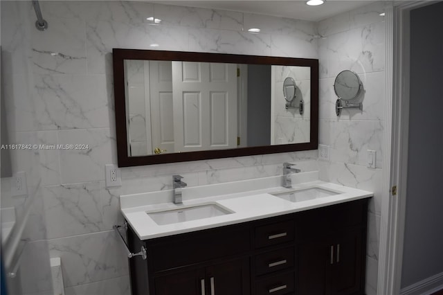 bathroom featuring vanity and tile walls