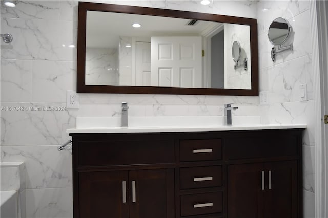 bathroom featuring vanity and tile walls