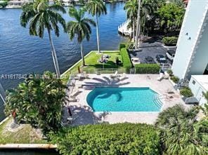 view of pool with a patio area and a water view