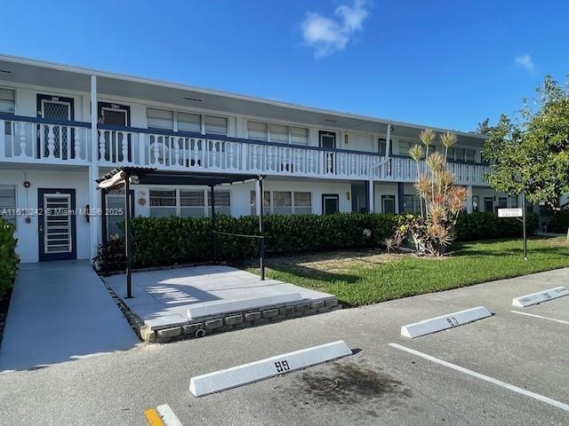 88 Tilford E Unit 88, Deerfield Beach, FL 33442 - view of building exterior with uncovered parking