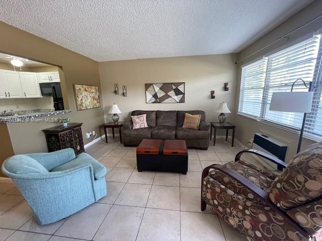 living room with light tile patterned floors and a textured ceiling