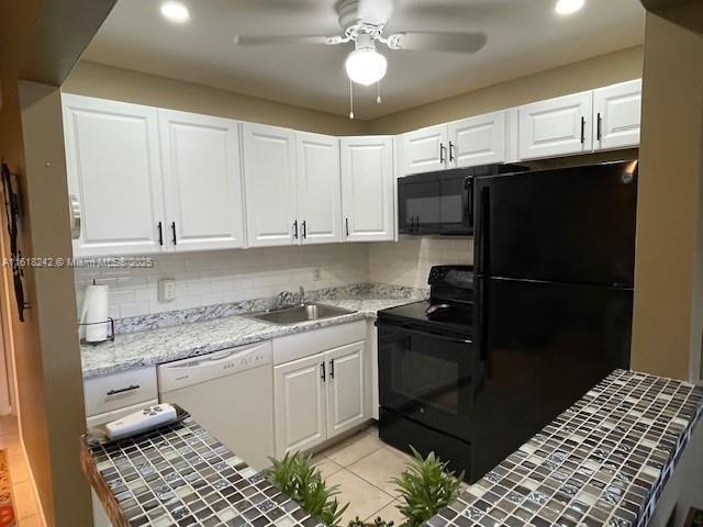88 Tilford E Unit 88, Deerfield Beach, FL 33442 - kitchen featuring a ceiling fan, a sink, black appliances, recessed lighting, and white cabinetry