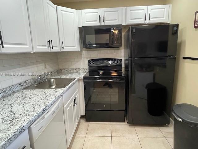 kitchen featuring light tile patterned floors, sink, white cabinetry, and black appliances