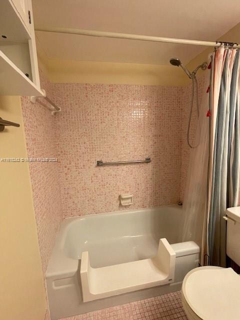 bathroom with curtained shower, tile patterned flooring, and toilet