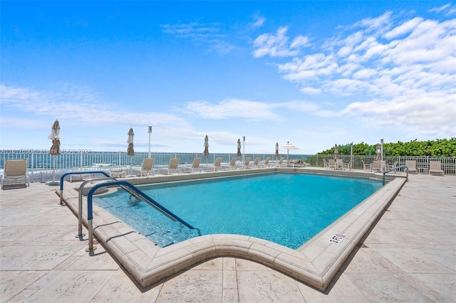 view of swimming pool with a patio