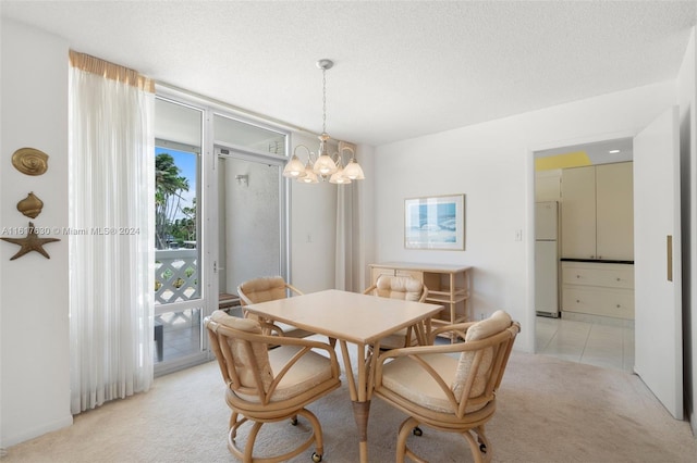 carpeted dining area with an inviting chandelier and a textured ceiling