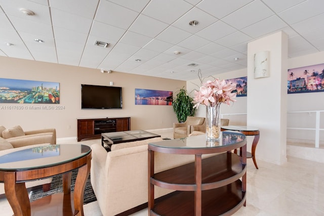 tiled living room featuring a drop ceiling