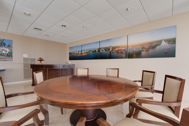 dining area featuring a paneled ceiling