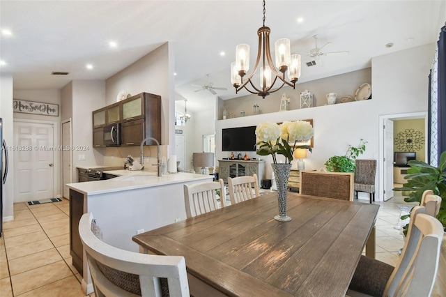 dining space with ceiling fan, light tile patterned floors, and sink