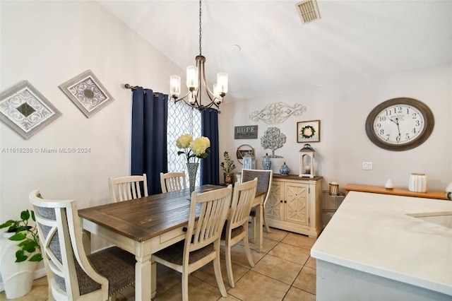 dining area with lofted ceiling, an inviting chandelier, and light tile patterned floors