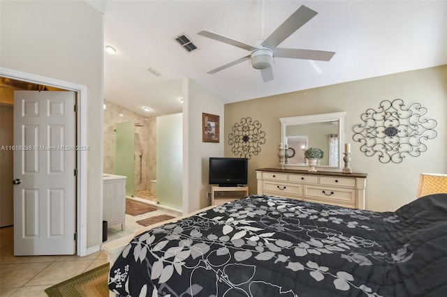 tiled bedroom featuring ceiling fan and ensuite bath