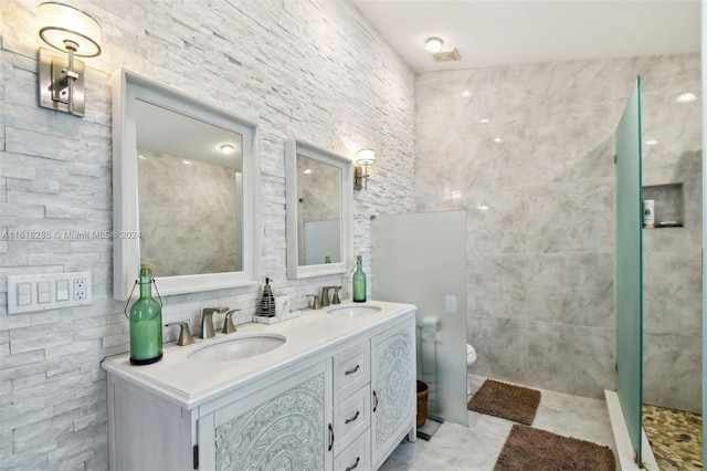 bathroom featuring vanity, tile patterned floors, walk in shower, tile walls, and toilet