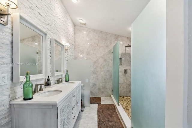 bathroom featuring vanity, tile walls, tile patterned floors, and tiled shower