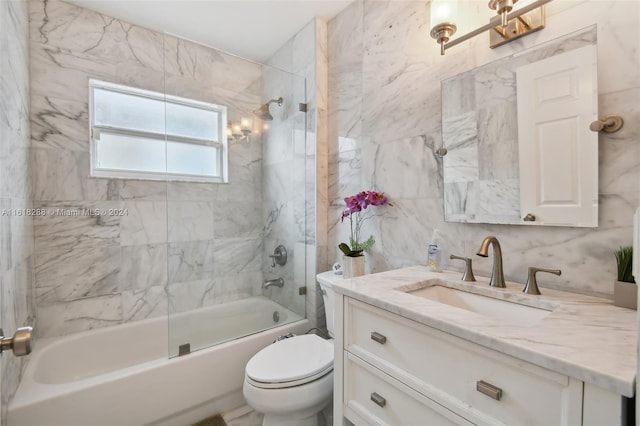 full bathroom featuring tile walls, backsplash, vanity, tiled shower / bath combo, and toilet