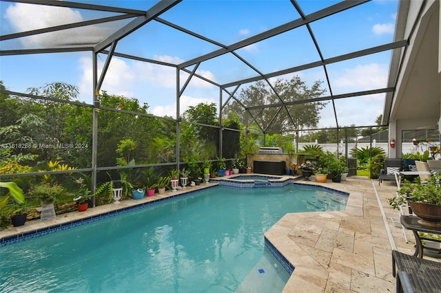 view of pool with a lanai, a patio, and an in ground hot tub