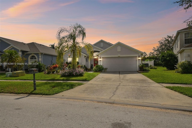 single story home with a yard and a garage