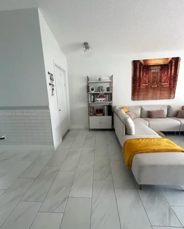 interior space featuring tile patterned flooring and a textured ceiling