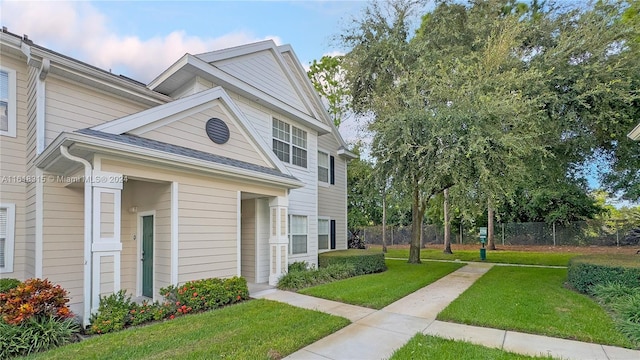 view of side of home with a yard