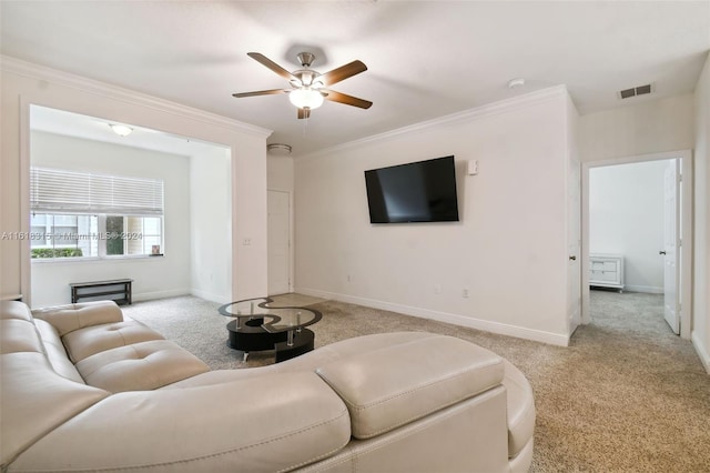 living room featuring light carpet, ceiling fan, and ornamental molding